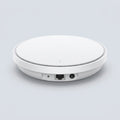 TP-Link Omada EAP773 Wi-Fi 7 access point showing circular matte white design and Ethernet port